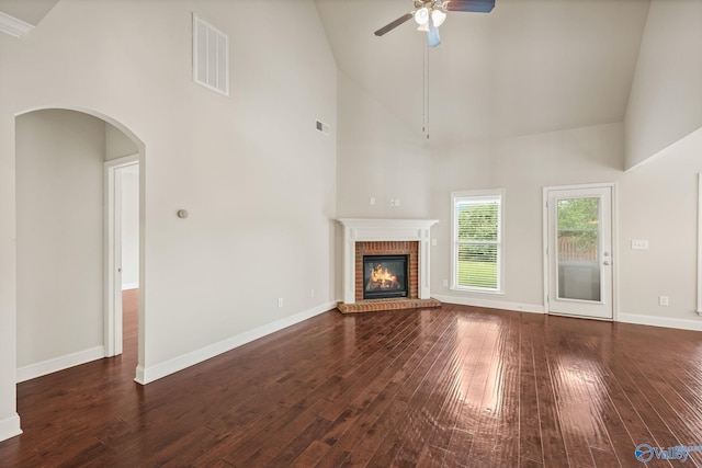 unfurnished living room with high vaulted ceiling, a ceiling fan, and visible vents
