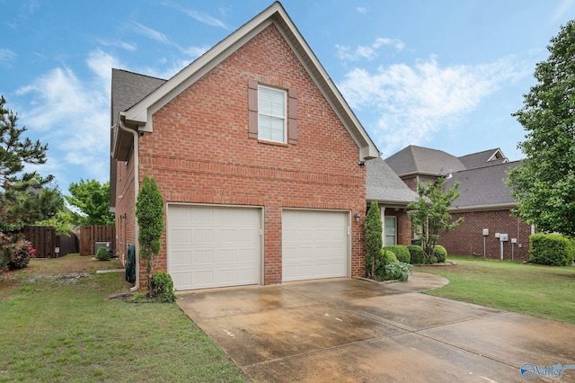 traditional-style home with brick siding, an attached garage, driveway, and a front lawn