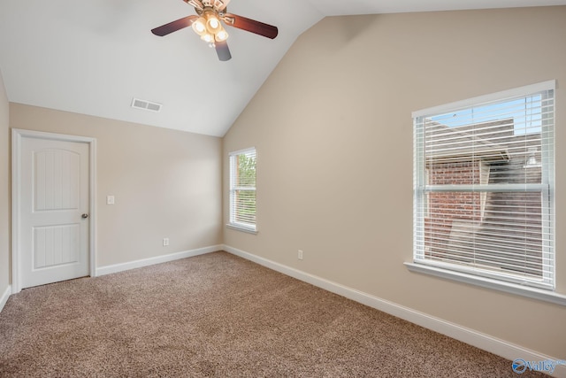 empty room with visible vents, a ceiling fan, carpet, and lofted ceiling