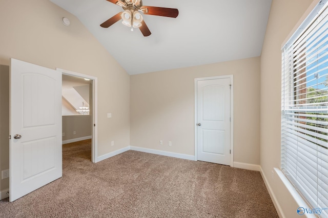 unfurnished bedroom with a ceiling fan, baseboards, carpet, and vaulted ceiling