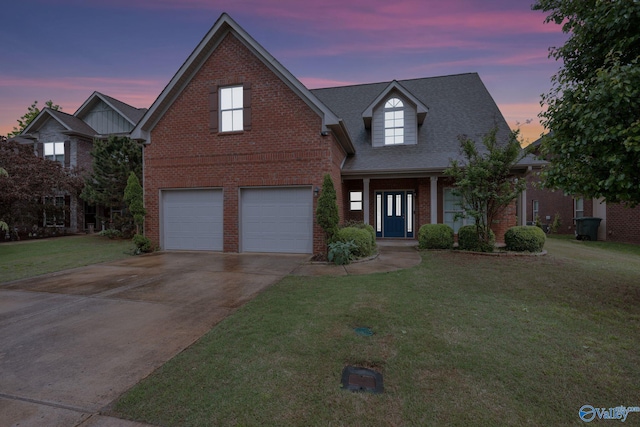 traditional home featuring a garage, brick siding, a shingled roof, concrete driveway, and a lawn