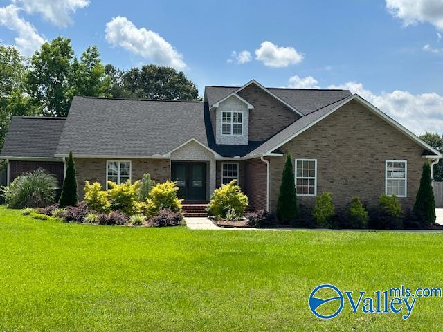 view of front facade featuring a front lawn and brick siding