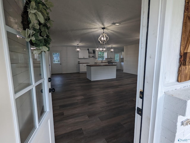 2537 Rexford St, Gadsden, AL 35903 - kitchen with dark wood-style floors, dark countertops, a chandelier, plenty of natural light, and a textured ceiling