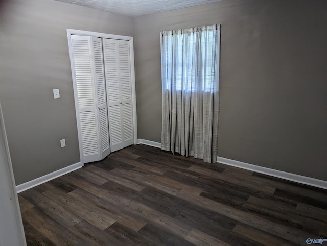 2537 Rexford St, Gadsden, AL 35903 - unfurnished bedroom with dark wood-style floors and a closet