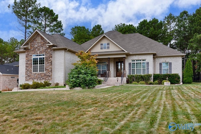 craftsman inspired home featuring a front lawn and a porch