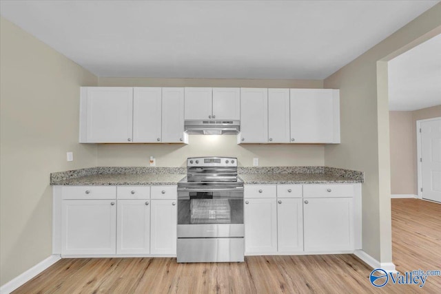 kitchen featuring under cabinet range hood, white cabinets, light stone countertops, light wood finished floors, and stainless steel range with electric stovetop