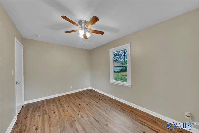 unfurnished room with ceiling fan, baseboards, and wood finished floors