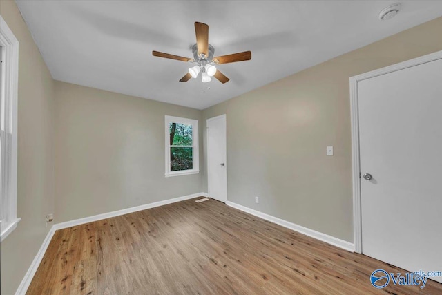 unfurnished room featuring ceiling fan, baseboards, and wood finished floors