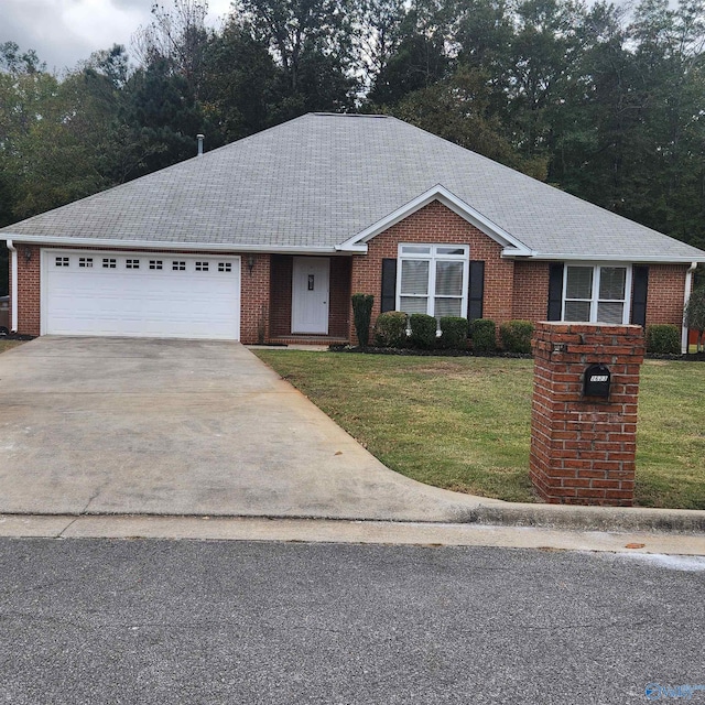 single story home featuring an attached garage, driveway, a front lawn, and brick siding