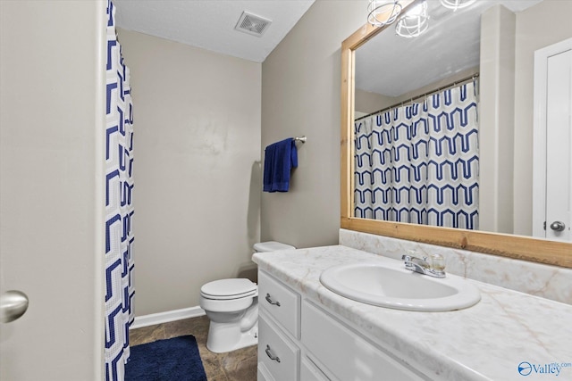 bathroom with toilet and vanity