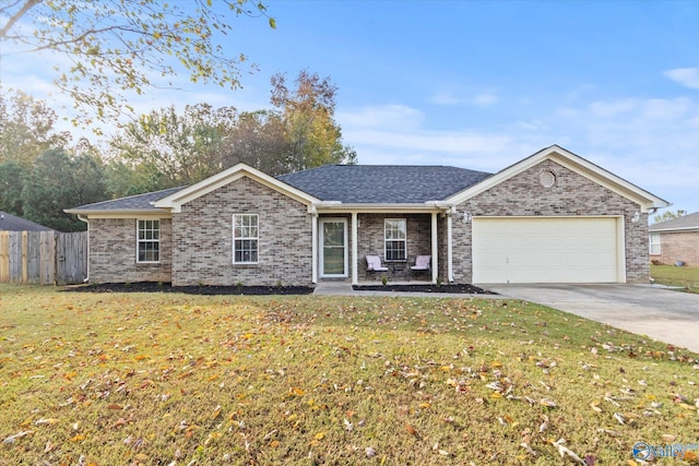 ranch-style house featuring a garage and a front yard