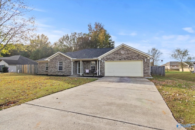 ranch-style home featuring a garage and a front yard