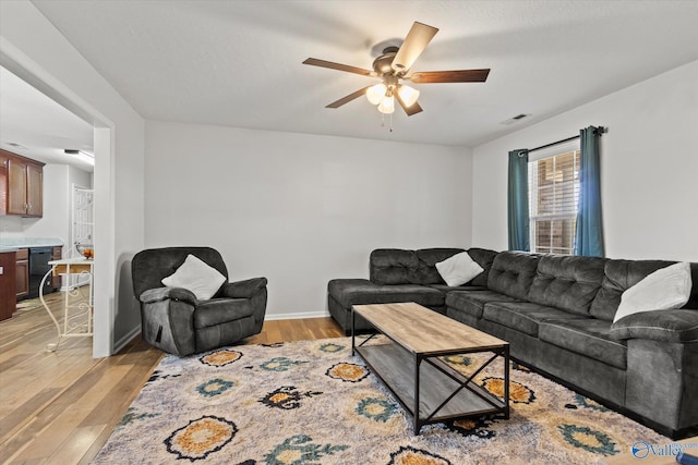 living room with light hardwood / wood-style floors and ceiling fan