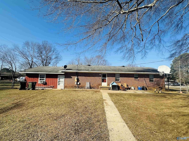 rear view of property with a lawn