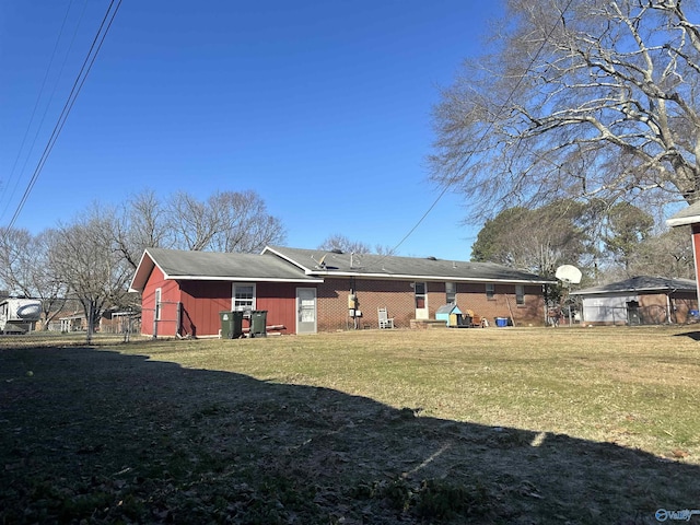 rear view of house with a lawn