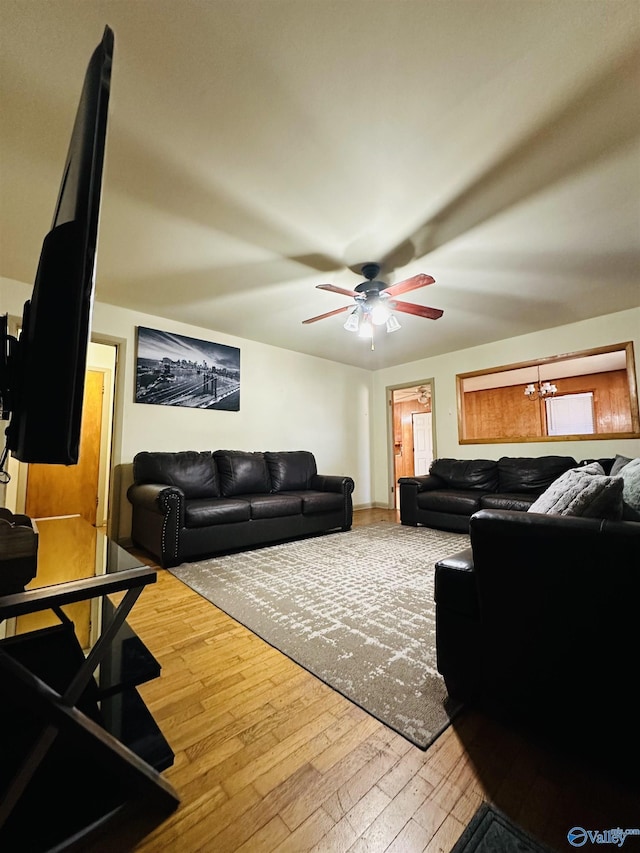 living room with ceiling fan and wood-type flooring