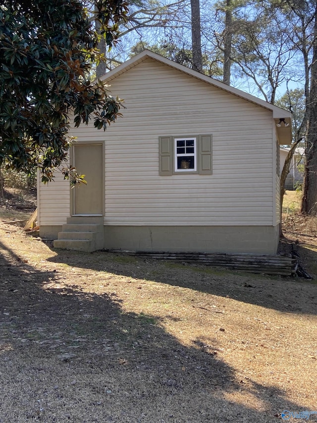 view of side of home featuring entry steps