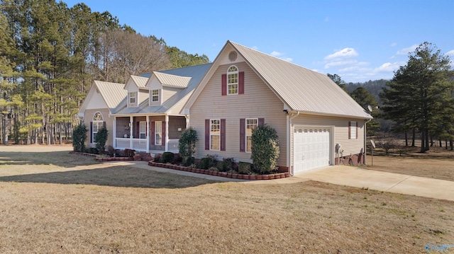 view of front of home featuring a porch, a garage, and a front yard