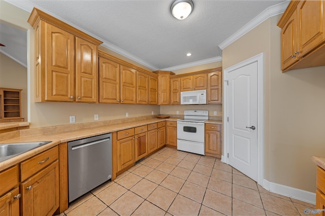 kitchen with crown molding, light tile patterned floors, a textured ceiling, and white appliances