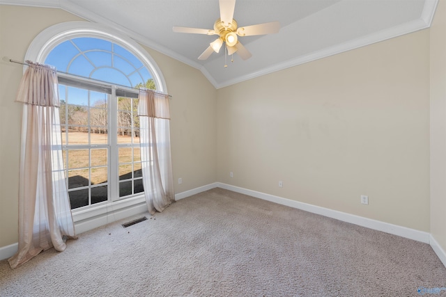 carpeted spare room featuring ornamental molding, lofted ceiling, and ceiling fan