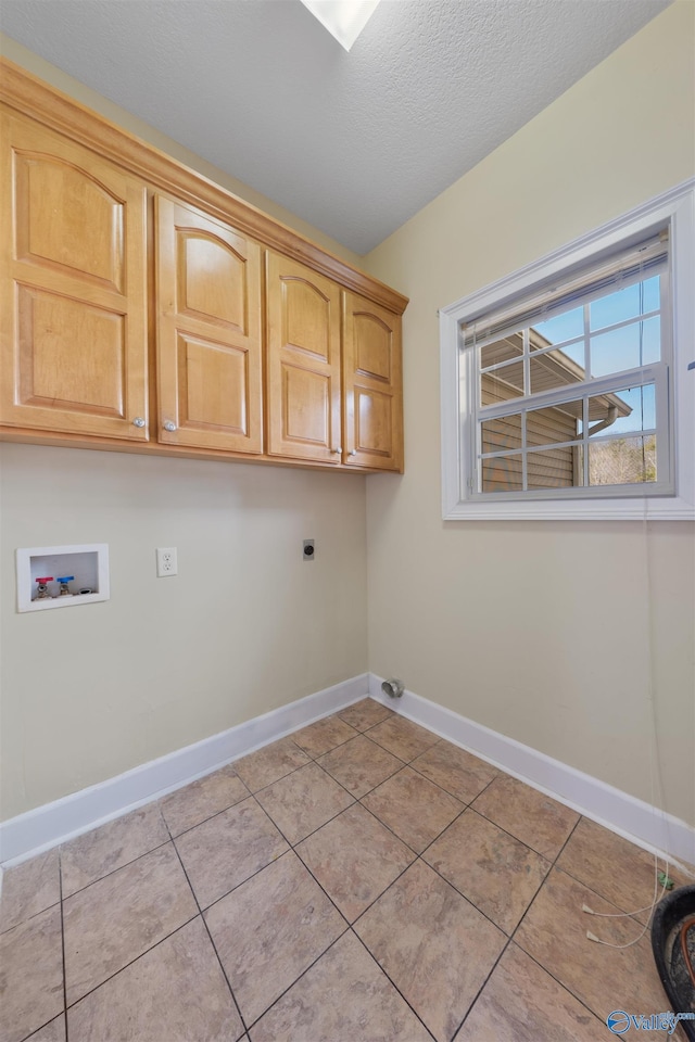 washroom featuring washer hookup, cabinets, hookup for an electric dryer, and light tile patterned flooring