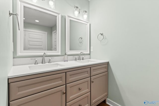 bathroom featuring a sink and double vanity