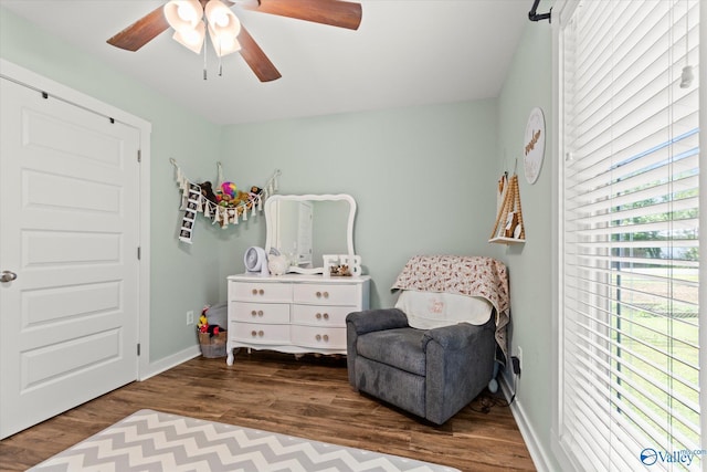 sitting room featuring baseboards, ceiling fan, and wood finished floors
