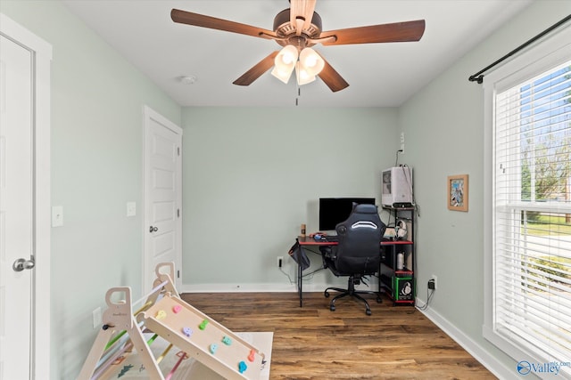 office space featuring baseboards, ceiling fan, and wood finished floors