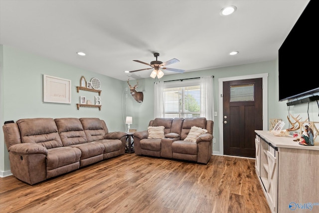 living area featuring light wood-style floors, a ceiling fan, and recessed lighting