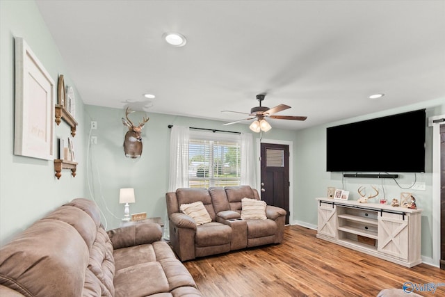 living room featuring recessed lighting, ceiling fan, and light wood-style flooring