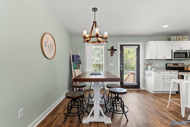 dining area with baseboards, recessed lighting, dark wood finished floors, and a notable chandelier