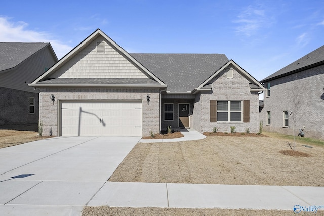 418 Tracer St, Huntsville, AL 35811 - craftsman-style home featuring a garage, driveway, brick siding, and roof with shingles