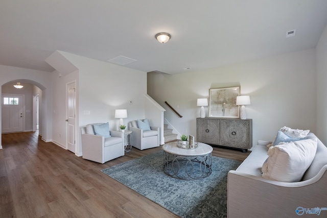 418 Tracer St, Huntsville, AL 35811 - living room with arched walkways, wood finished floors, stairway, and baseboards