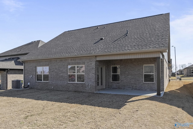 418 Tracer St, Huntsville, AL 35811 - rear view of property featuring roof with shingles, brick siding, central AC unit, and a patio