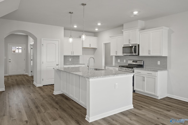 418 Tracer St, Huntsville, AL 35811 - kitchen featuring a sink, stainless steel appliances, arched walkways, dark wood-style floors, and recessed lighting