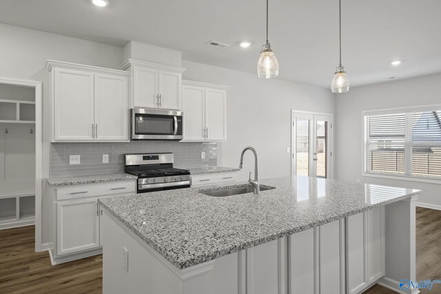418 Tracer St, Huntsville, AL 35811 - kitchen with appliances with stainless steel finishes, a sink, dark wood-style floors, white cabinetry, and recessed lighting
