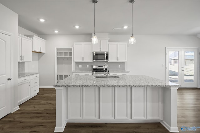 418 Tracer St, Huntsville, AL 35811 - kitchen featuring stainless steel appliances, a sink, white cabinetry, tasteful backsplash, and dark wood-type flooring
