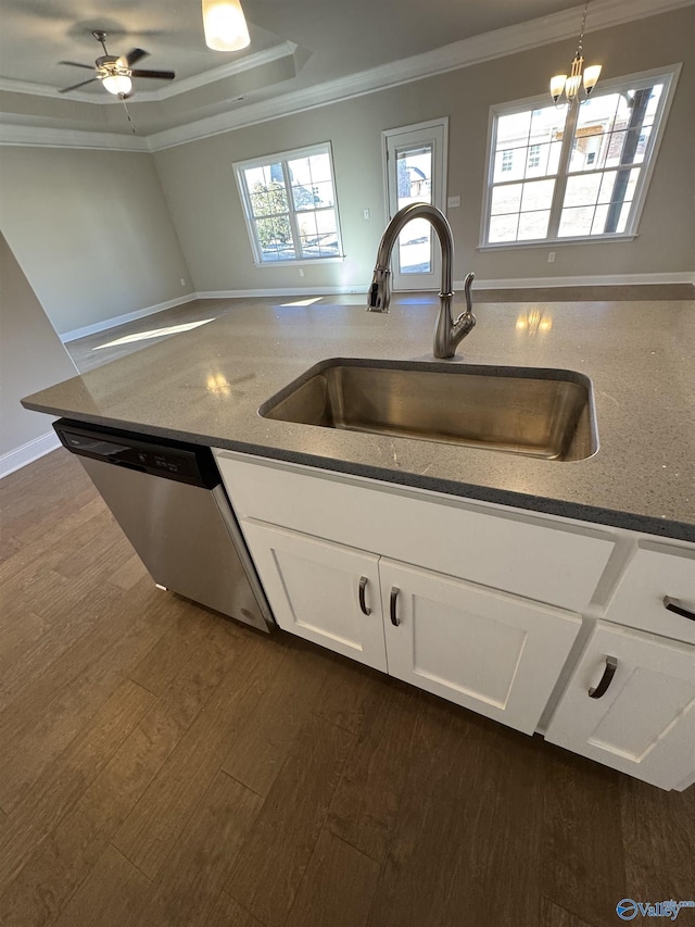 kitchen featuring pendant lighting, dishwasher, sink, white cabinets, and ornamental molding