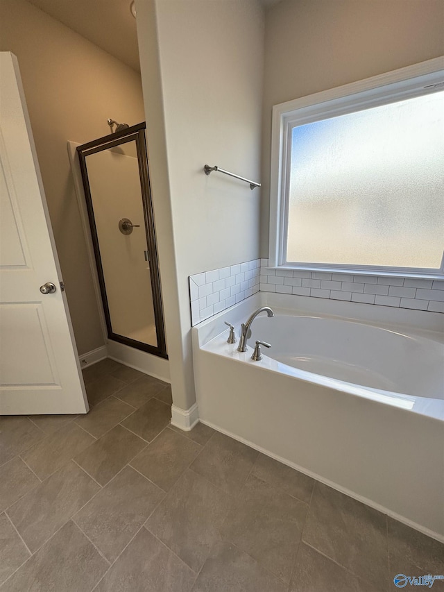 bathroom featuring plus walk in shower and tile patterned floors