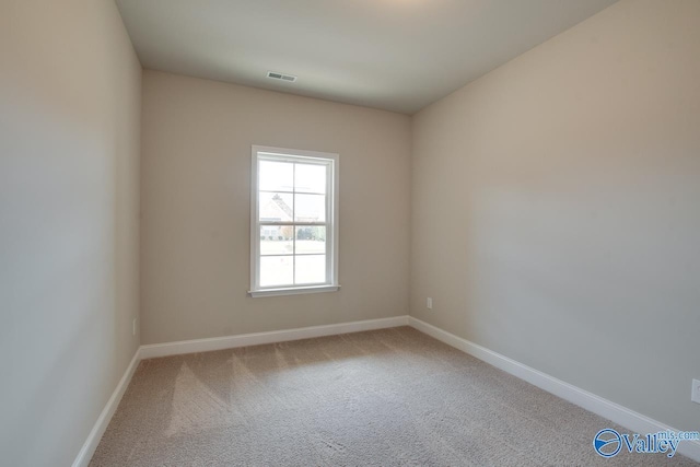 unfurnished room featuring light carpet