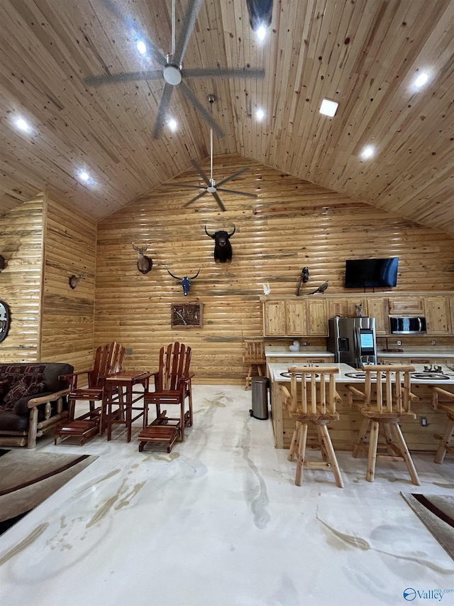 unfurnished dining area featuring wooden ceiling, high vaulted ceiling, and wood walls