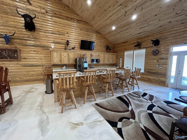 dining area with wooden ceiling, wooden walls, rustic walls, and high vaulted ceiling