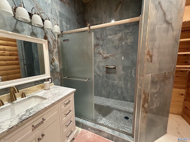 bathroom with vanity and a shower with shower door