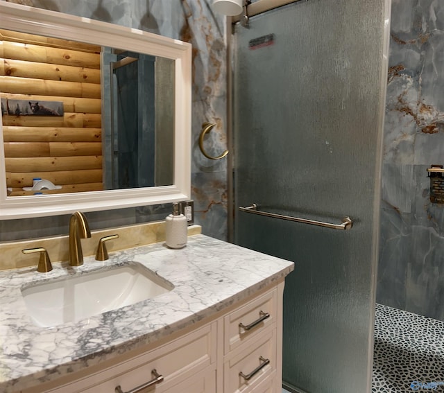 bathroom with an enclosed shower, vanity, and log walls