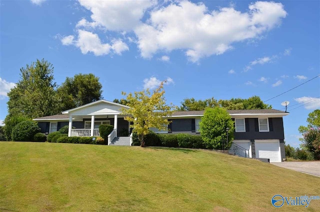 ranch-style house with a front yard, covered porch, driveway, and an attached garage