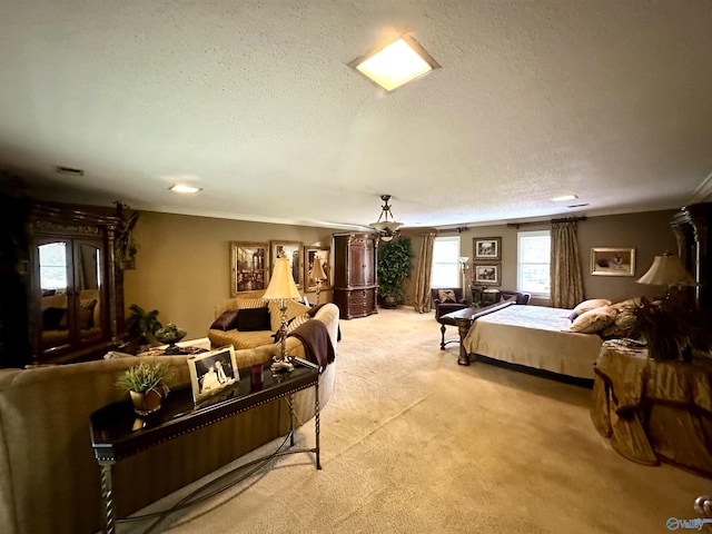 bedroom with ornamental molding, light carpet, and a textured ceiling