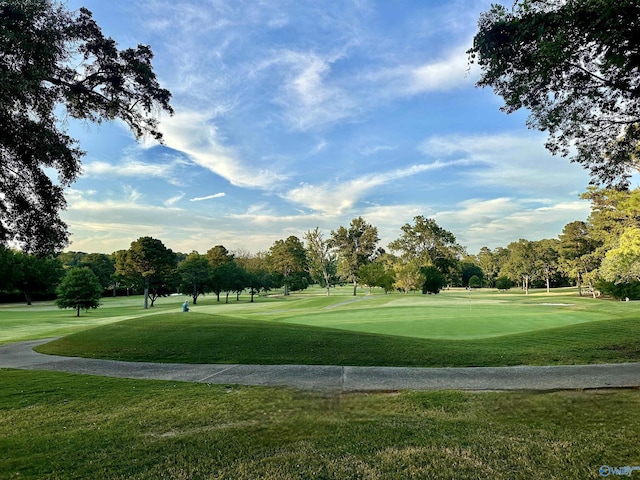 view of community featuring a lawn and golf course view