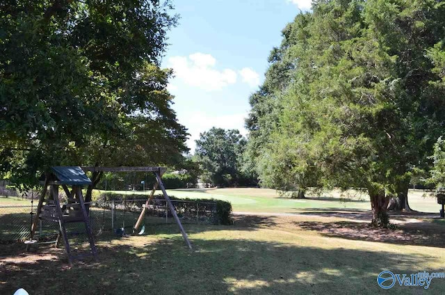 exterior space featuring playground community and fence