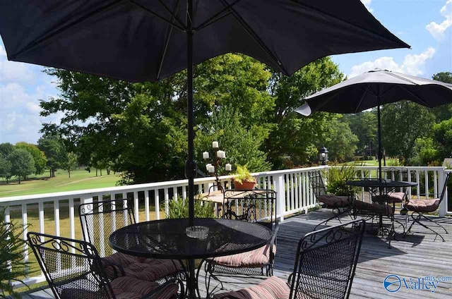 wooden deck featuring outdoor dining area