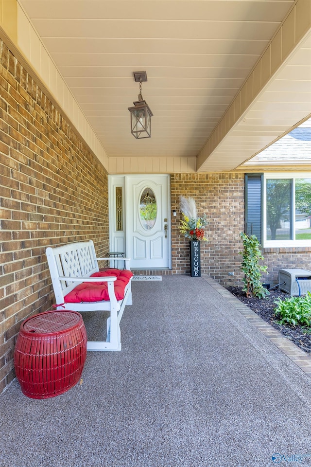 view of exterior entry featuring brick siding